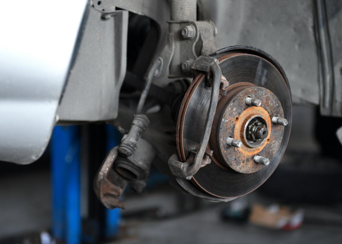 Brake inspection during an MOT test at All Vehicle Services in Sittingbourne